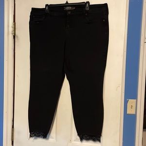 EUC Torrid black “ankle skinny” jeans with raw lace hem.